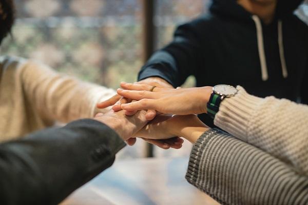 Five people holding each other hands Five people holding each other hands